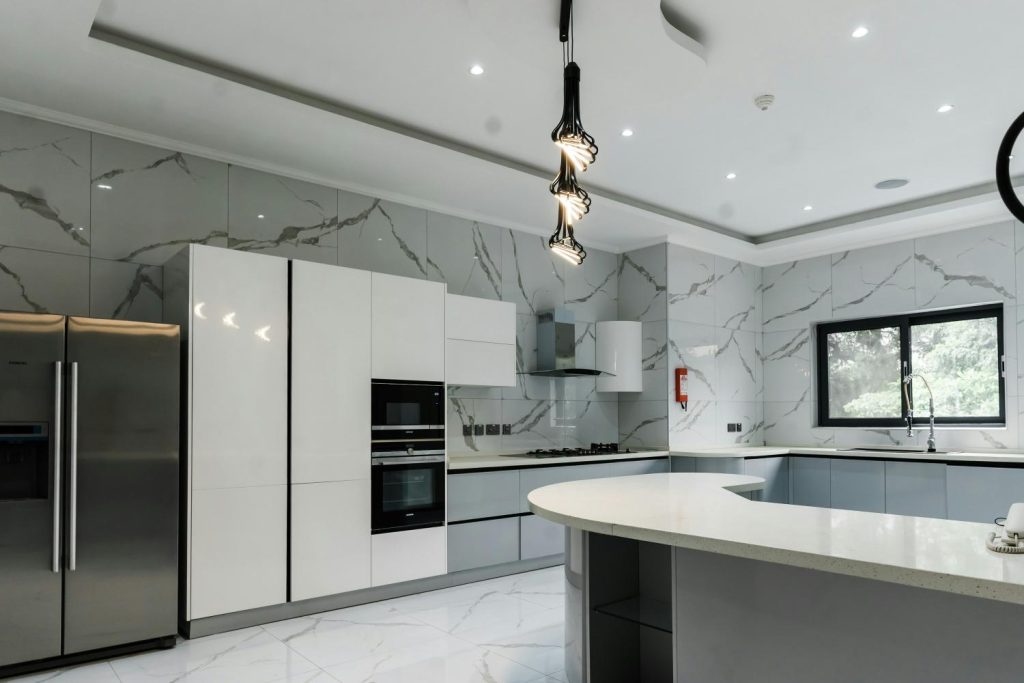 Sleek kitchen with marble walls and modern appliances