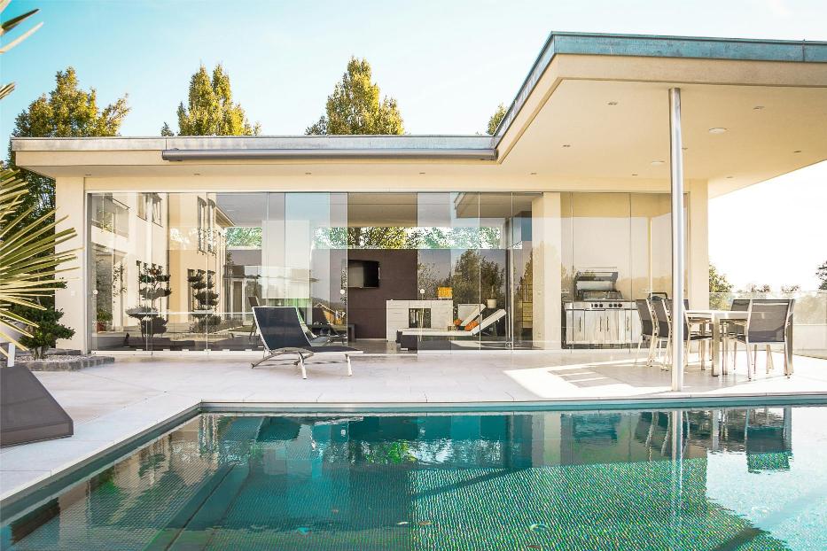 Modern house with outdoor pool and seating area