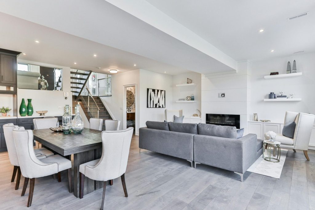 Open-concept living and dining room in gray tones.