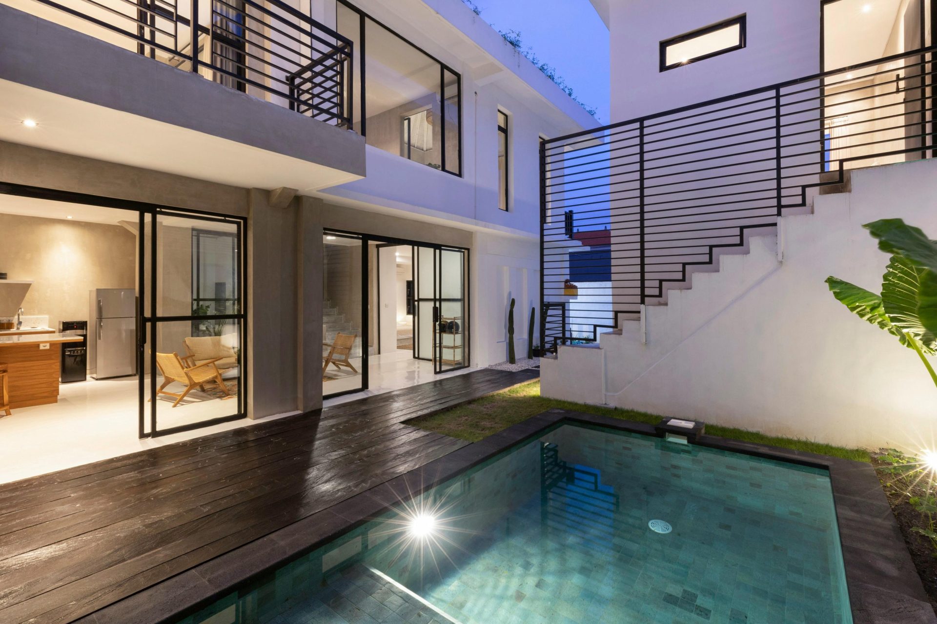 Modern home with a well-lit evening pool